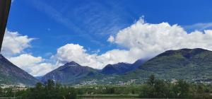 a view of a mountain range with clouds in the sky at B&B La Terrazza in Domodossola