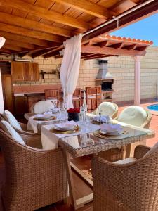 einen Tisch und Stühle auf einer Terrasse mit Kamin in der Unterkunft Villa Claudia - HEATED POOL by VV Canary Ocean Homes in Puerto de Santiago