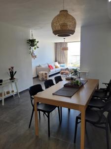 a dining room with a wooden table and chairs at view point relax in Eilat