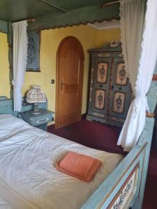 a bedroom with a bed with an orange towel on it at Kleines Brauhaus Ingolstadt in Ingolstadt