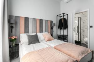 a bedroom with a large bed with a striped wall at Old Town Residence - Premium Aparthotel in Krakow