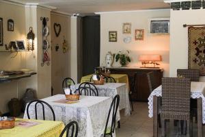 a restaurant with two tables and chairs and a counter at Pousada Mucuripe in Fortaleza