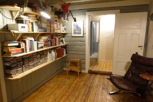 a room with book shelves filled with books at Most photographed house in Reine in Reine