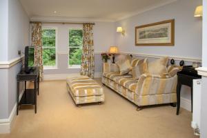 a living room with a couch and a chair at The Dower House Hotel in Woodhall Spa