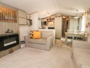 a living room with a couch and a table at Rubys Retreat in Leek