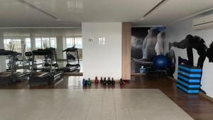 a room with a gym with a painting on the wall at Trend 2414 in Goiânia