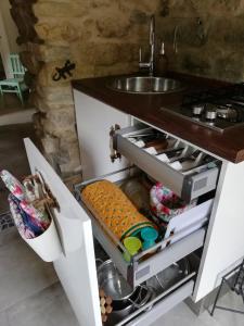 a kitchen with a sink and a counter top at CASA LUCERTOLA in Apricale