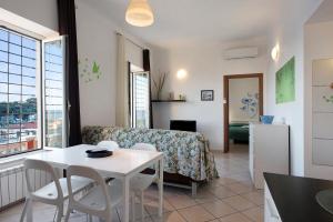 a living room with a table and a dining room at Trilocale in villa vista mare Apt 1 in Varazze