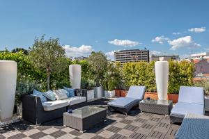 a patio with couches and chairs on a roof at Hotel Lisboa Plaza - Lisbon Heritage Collection - Avenida in Lisbon