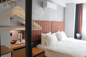 a hotel room with a bed and a desk at Woynpoint Hotel&Cafe in Fethiye