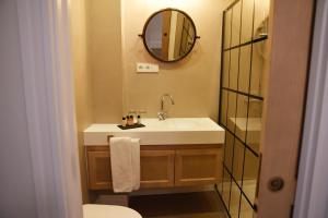 a bathroom with a sink and a mirror at Honest Sevilla Apartments in Seville
