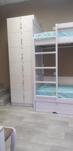 a bunk bed with white cabinets and a purple bunk bed at Hotel Aragvi in Cherkasy