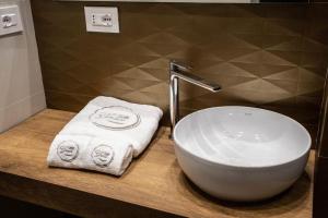 a bathroom with a white sink and a towel at B&B Villa Grace in Bari