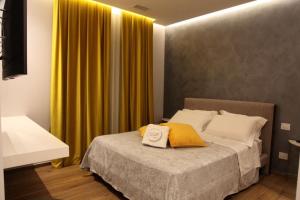 a bedroom with a bed with a yellow curtain at B&B Villa Grace in Bari