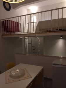 a room with a table and a bunk bed at Casa vacanze A Milorda in Letojanni +61 photos