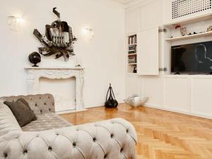 a white living room with a couch and a tv at Vallazze Luxury in Milan