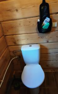 a toilet in a small room with a backpack at Piglet house in Alytus