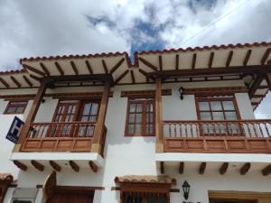 a building with wooden balconies on the side of it at Muisca Hotel Villa de Leyva in Villa de Leyva