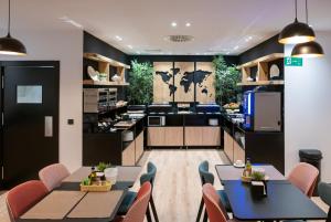 a kitchen with tables and chairs in a room at Hotel Boutique Puerta de las Granadas in Granada