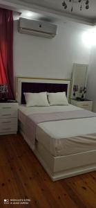 a bedroom with a large white bed in a room at شقةفاخرةبجليم على البحر مباشرة in Alexandria