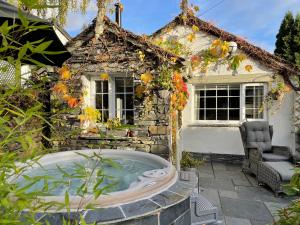a hot tub in front of a house at Marys Cottage, Grasmere, Dog Friendly, Hot Tub in Grasmere