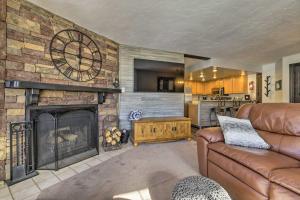 a living room with a large stone fireplace at The Bunk House - Ski-InandSki-Out at Giant Steps! in Brian Head