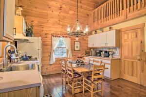 a kitchen with a table and chairs in a cabin at Rustic Rothbury Cabin with Resort Amenity Access! in Rothbury