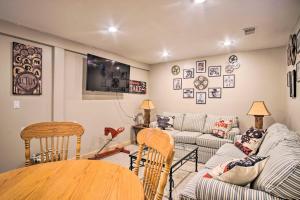 a living room with a couch and a table at Rustic Rothbury Cabin with Resort Amenity Access! in Rothbury