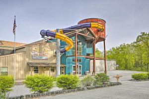 a water slide in front of a building at Rustic Rothbury Cabin with Resort Amenity Access! in Rothbury