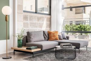a living room with a couch and a table at Mr. Agrippa - By TLV2GO in Jerusalem