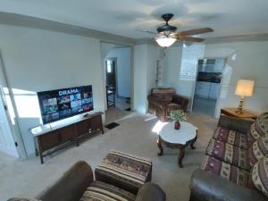 a living room with couches and a flat screen tv at Rancher's Capitol Lodge in Cheyenne