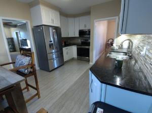 a kitchen with a stainless steel refrigerator freezer at Rancher's Capitol Lodge in Cheyenne