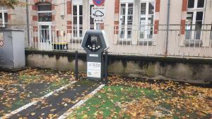 a parking meter sitting on the side of a street at Maison de charme pour 6 au coeur de l'Auvergne in Brassac-les-Mines