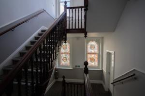 a staircase with two stained glass windows in a building at The Hop Inn in Bournemouth