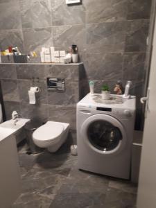 a bathroom with a washing machine and a toilet at Slatka sobica za dvoje sa upotrebom zajednicke kuhinje i kupaonice in Zagreb +10 photos