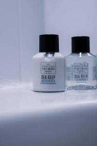 two bottles of soap sitting on a shelf at West End Escape - Prime Location in Glasgow