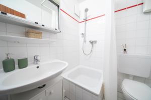 a white bathroom with a sink and a shower at Studio Shiny - Zentral mit Balkon - Messe - Küche in Neuss +9 photos