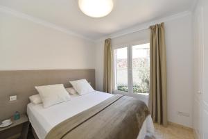 a bedroom with a large bed and a window at Chalet Santa Ana 19 by VillaGranCanaria in Playa del Ingles +29 photos