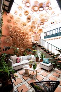 a living room with a couch and a staircase at Sie Casa Hotel in Villa de Leyva