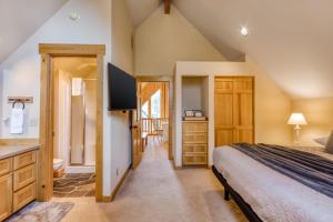 a bedroom with a king sized bed and a bathroom at Eagle Crest Family Friendly Chalet in Redmond +36 photos