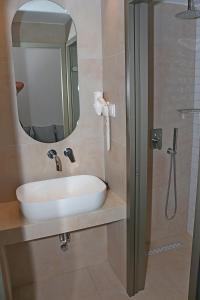 a bathroom with a sink and a mirror at Oneiro Zois in Prinos