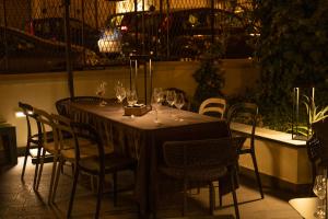 a table with wine glasses and chairs on a patio at Albergo Centrale in Lamezia Terme