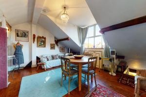 a living room with a table and a couch at Beautiful 1bed attic wterrace in North Kensington in London