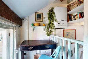 a staircase with a wooden table in a room at Beautiful 1bed attic wterrace in North Kensington in London