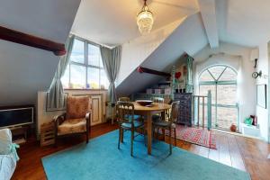 a dining room with a table and chairs in a room at Beautiful 1bed attic wterrace in North Kensington in London