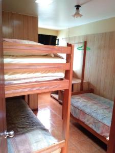 a room with two bunk beds in a house at Hospedaje Del Pilar en Magdalena del Mar in Lima