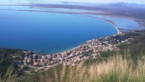a town on a hill next to a body of water at Delfini Hotel in Menídion +69 photos