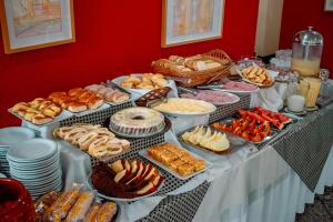 a table with many different types of food on it at Plaza Dutra Hotel in Caçapava