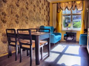 a dining room with a table and chairs at Stela's Apartments - Vysehrad in Prague