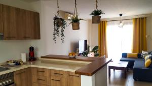 a kitchen with a counter top and a living room at Aiolos 20 in Puerto Calero